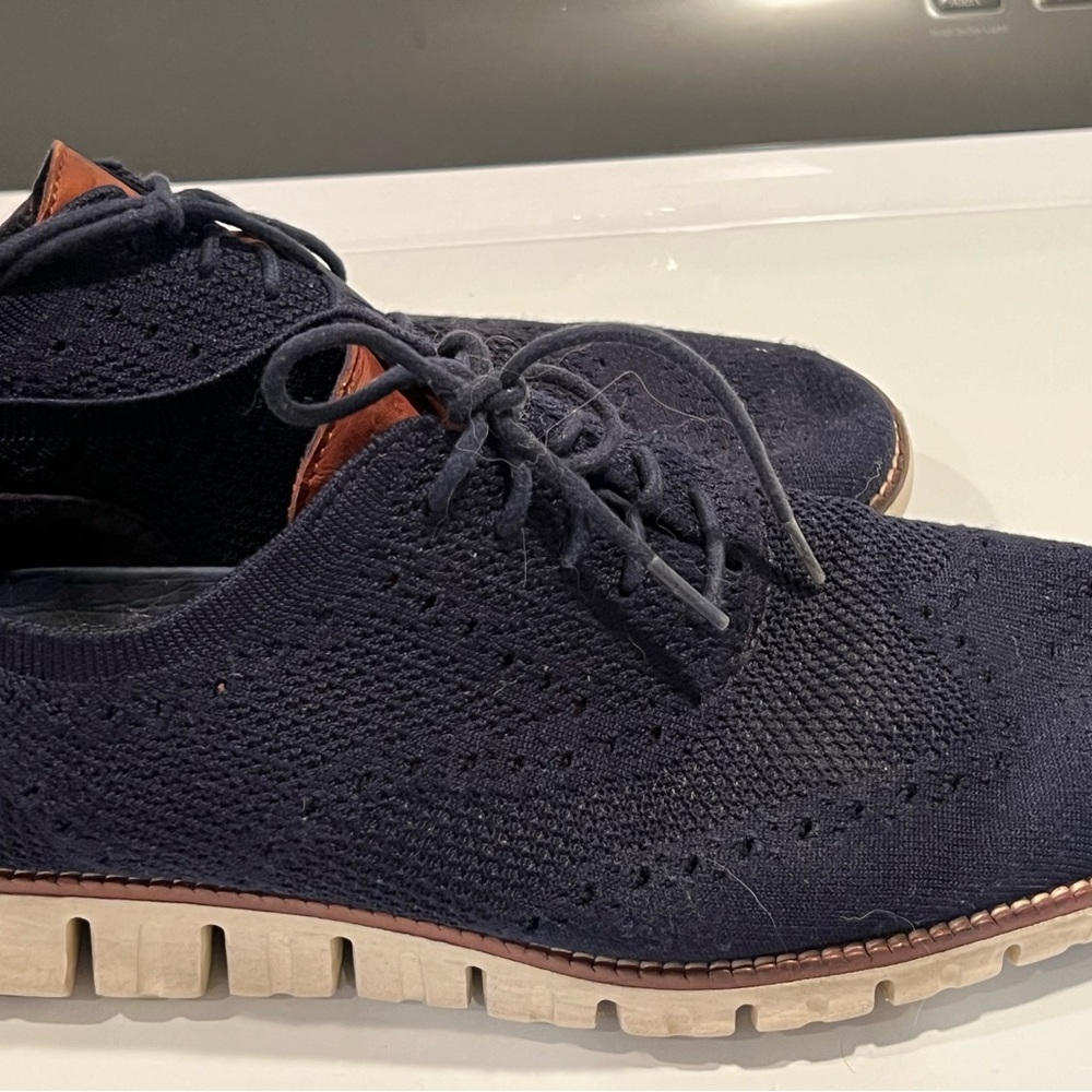 Navy blue shoe with brown accents and white sole